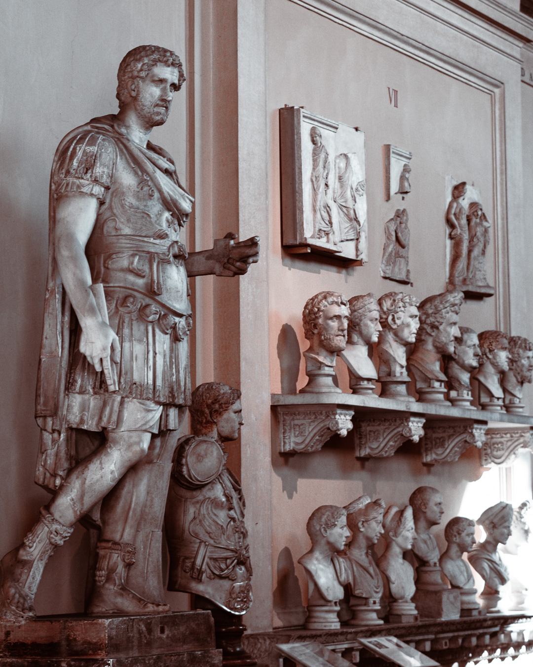 Sculpture of Antoninus Pius and several busts in the background in the vatican