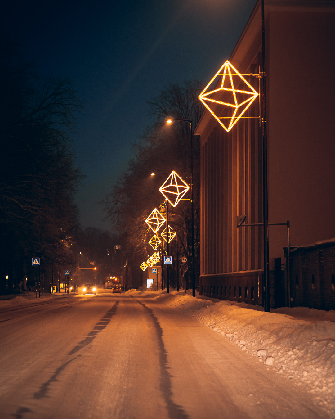 evening street lit up by warm coloured decorations