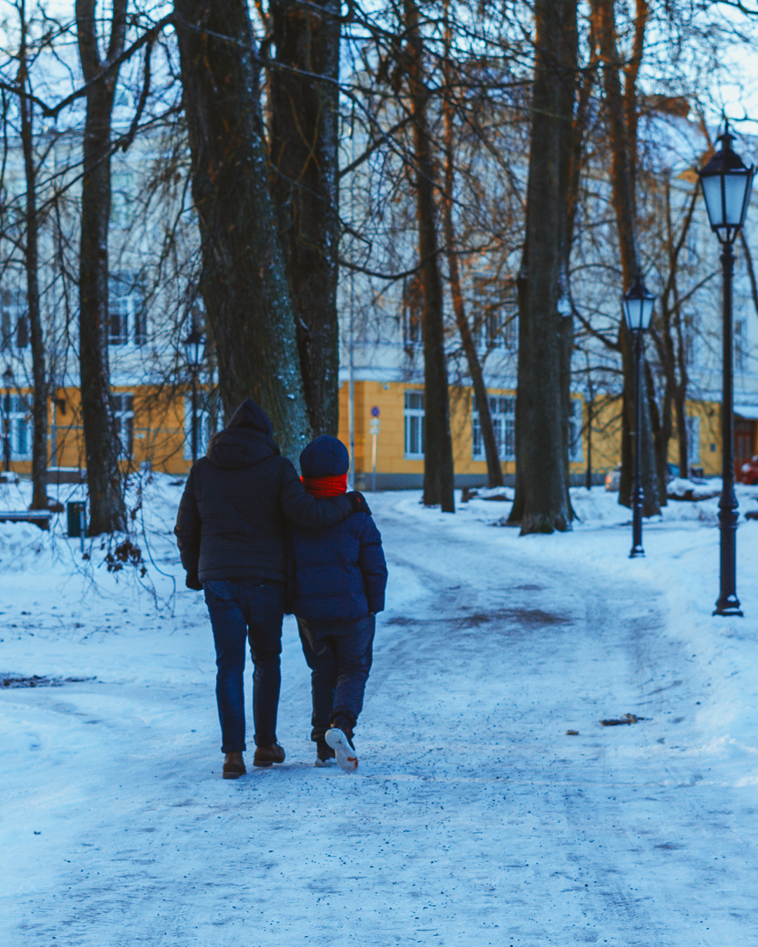 My father and brother walking together on a snowy road